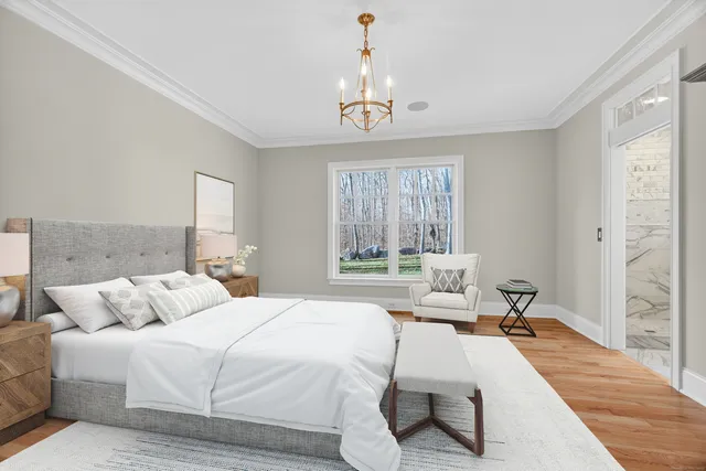 a spacious bedroom with a bed and a chandelier