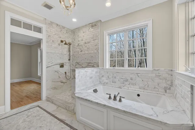 a bathroom with a bathtub and a shower