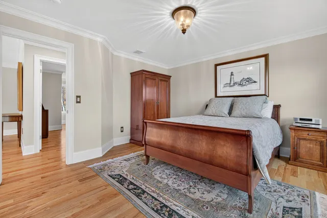 a bedroom with a bed and a chandelier