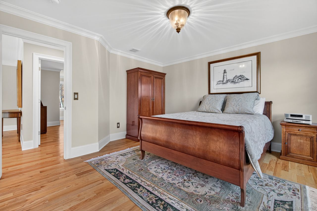 401 Fox Hopyard Road East Haddam, CT 06423 - Photo 24 of 38 a bedroom with a bed and a chandelier