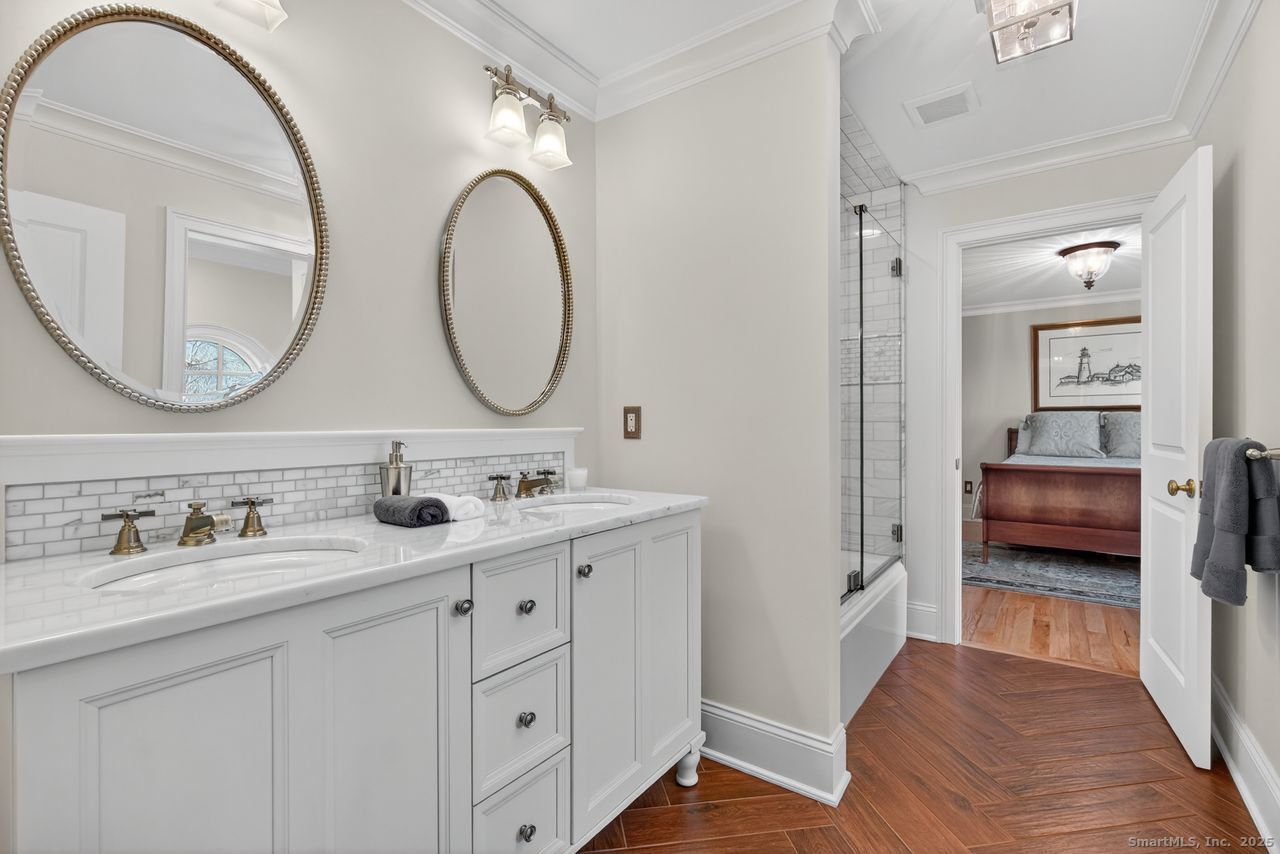 401 Fox Hopyard Road East Haddam, CT 06423 - Photo 25 of 38 a en suite bathroom with a double vanity sink and a mirror