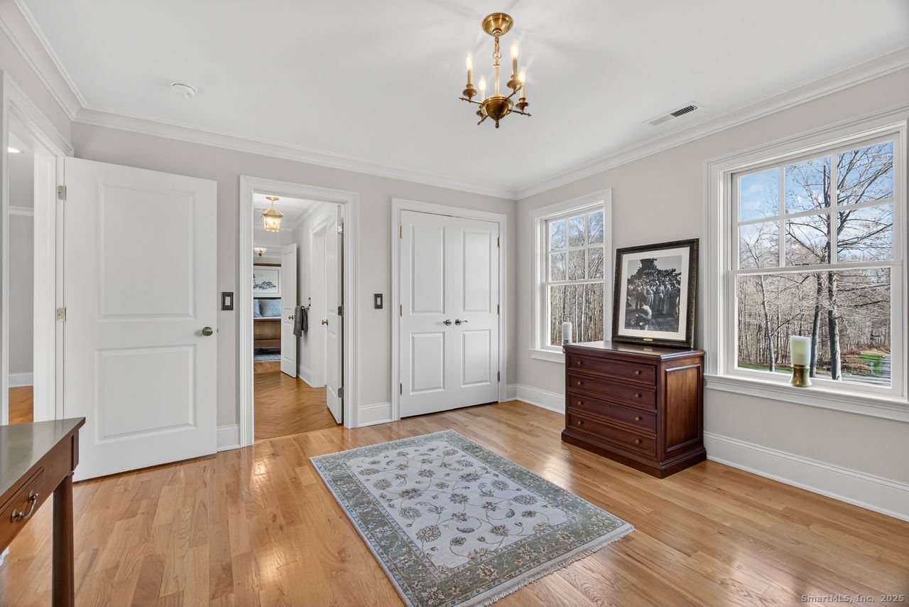 401 Fox Hopyard Road East Haddam, CT 06423 - Photo 27 of 38 wooden floor with windows and chandelier in a room