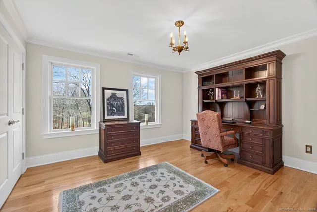 a view of a livingroom with wooden floor and a flat screen tv