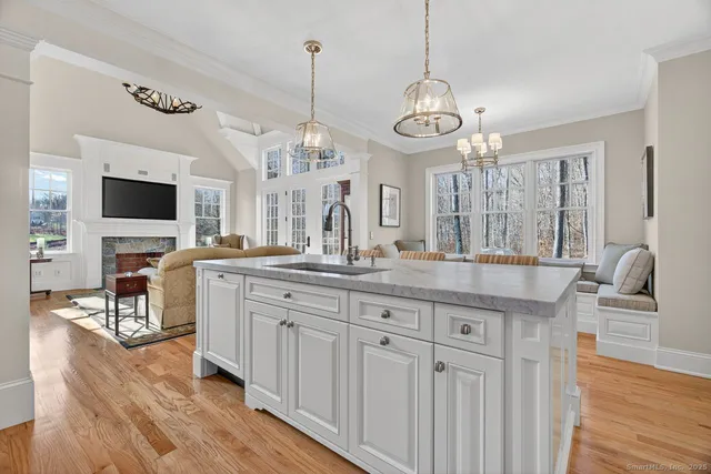 a open kitchen with stainless steel appliances granite countertop a stove and cabinets with wooden floor