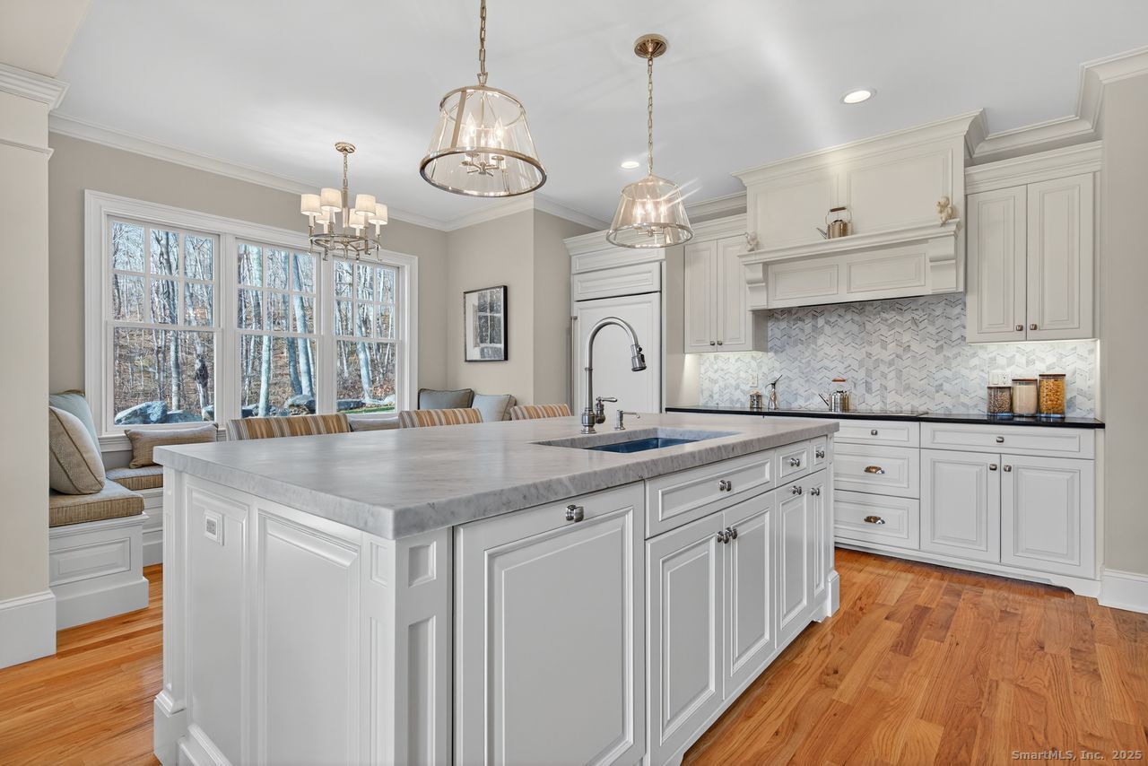 401 Fox Hopyard Road East Haddam, CT 06423 - Photo 8 of 38 a large kitchen with granite countertop a large island in the center and stainless steel appliances