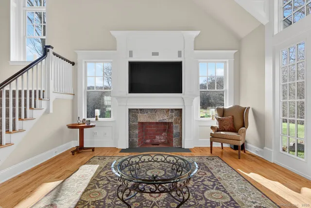 a living room with furniture fireplace and window