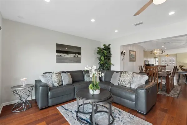 a living room with furniture and wooden floor