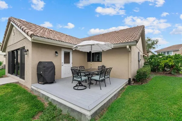 a view of a patio with table and chairs