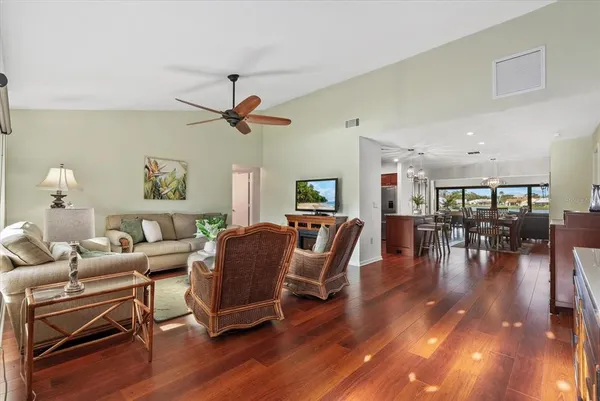 a living room with furniture and wooden floor