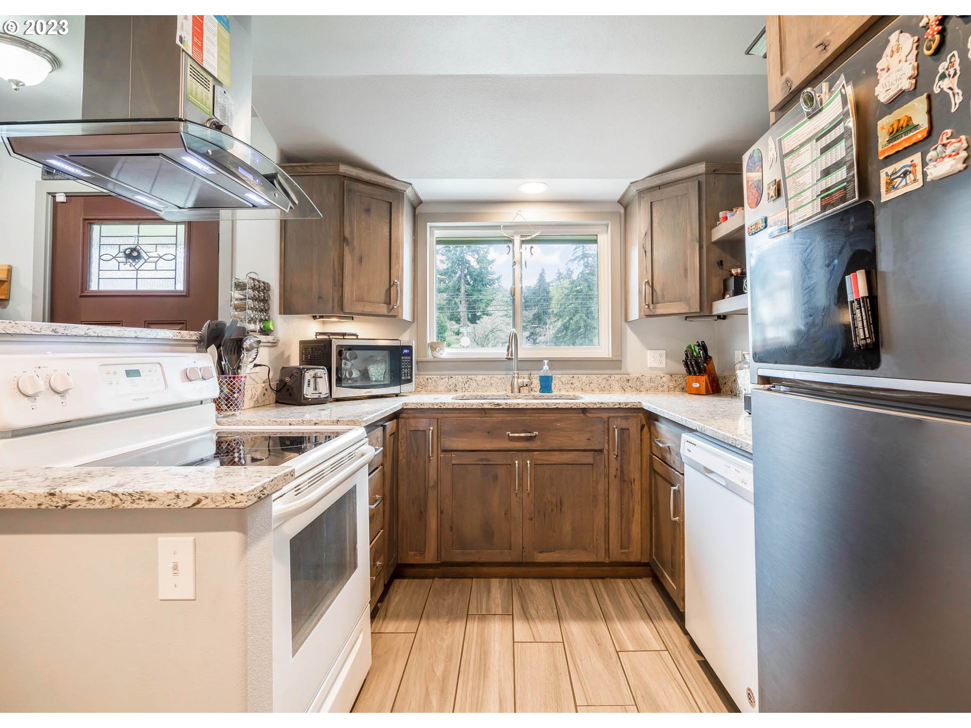 6840 Main Street Springfield, OR 97478 - Photo 10 of 28 a kitchen with a sink stove and cabinets