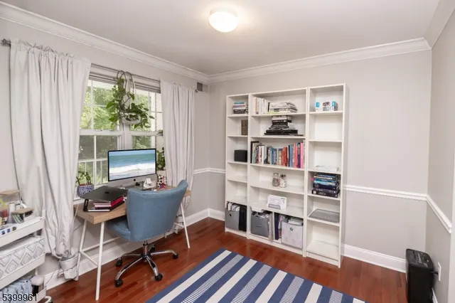 a room with a workspace and a bookshelf