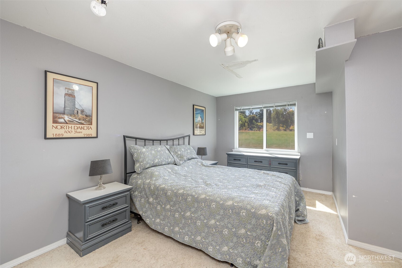 14415 196th Avenue Southeast Renton, WA 98059 - Photo 15 of 23 a bedroom with a bed and a chandelier