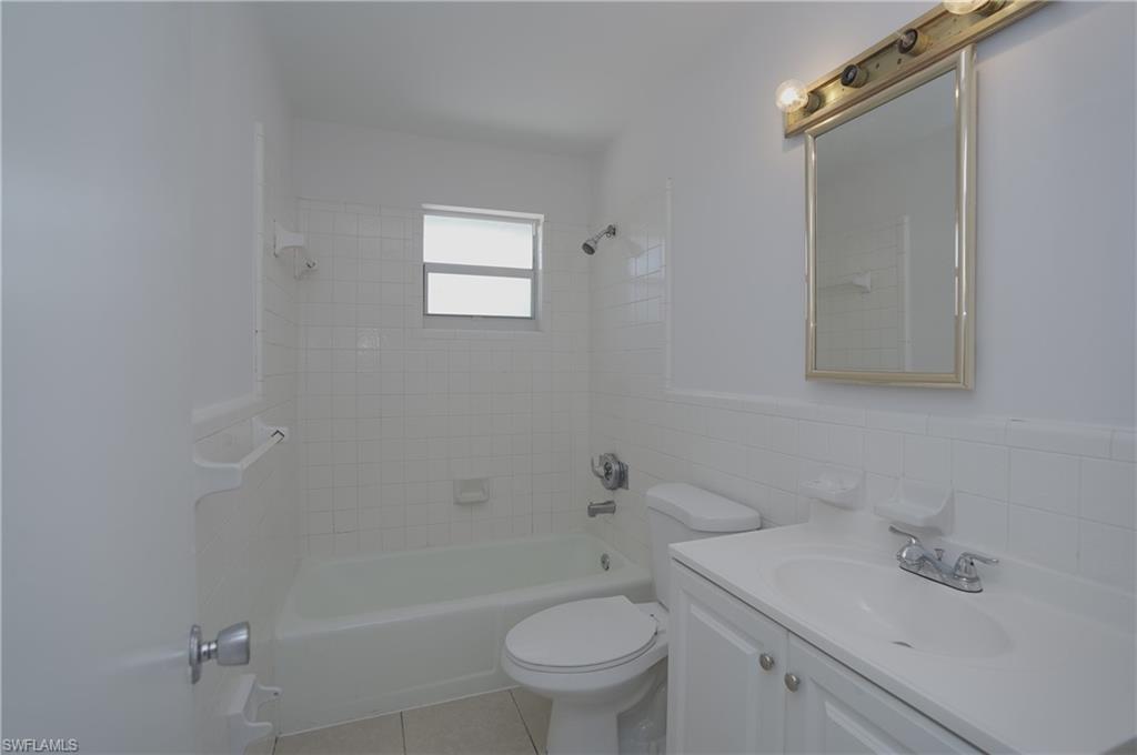 1195 South Alhambra Circle Naples, FL 34103 - Photo 18 of 34 a bathroom with a sink a toilet and shower