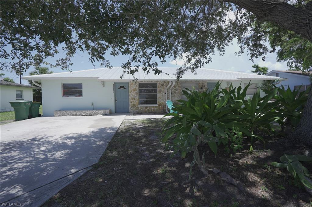 1195 South Alhambra Circle Naples, FL 34103 - Photo 2 of 34 a view of a house with a yard
