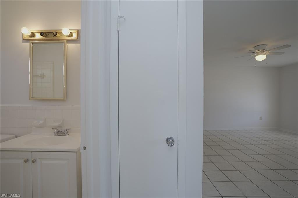 1195 South Alhambra Circle Naples, FL 34103 - Photo 24 of 34 a bathroom with a sink and mirror