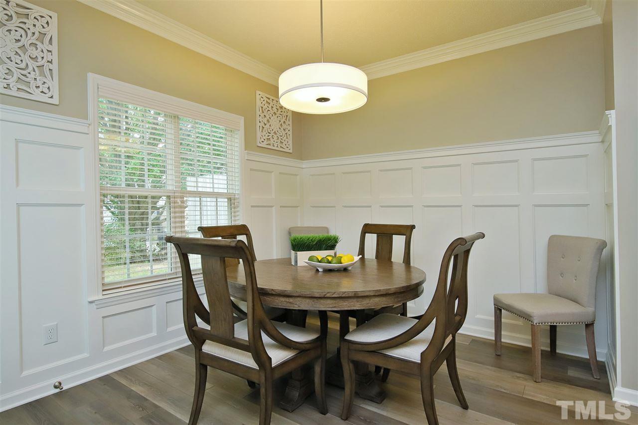 2412 Pumpkin Ridge Way Raleigh, NC 27604 - Photo 11 of 30 Beautiful breakfast area with wainscoting, LVP flooring, leading to outdoor private patio