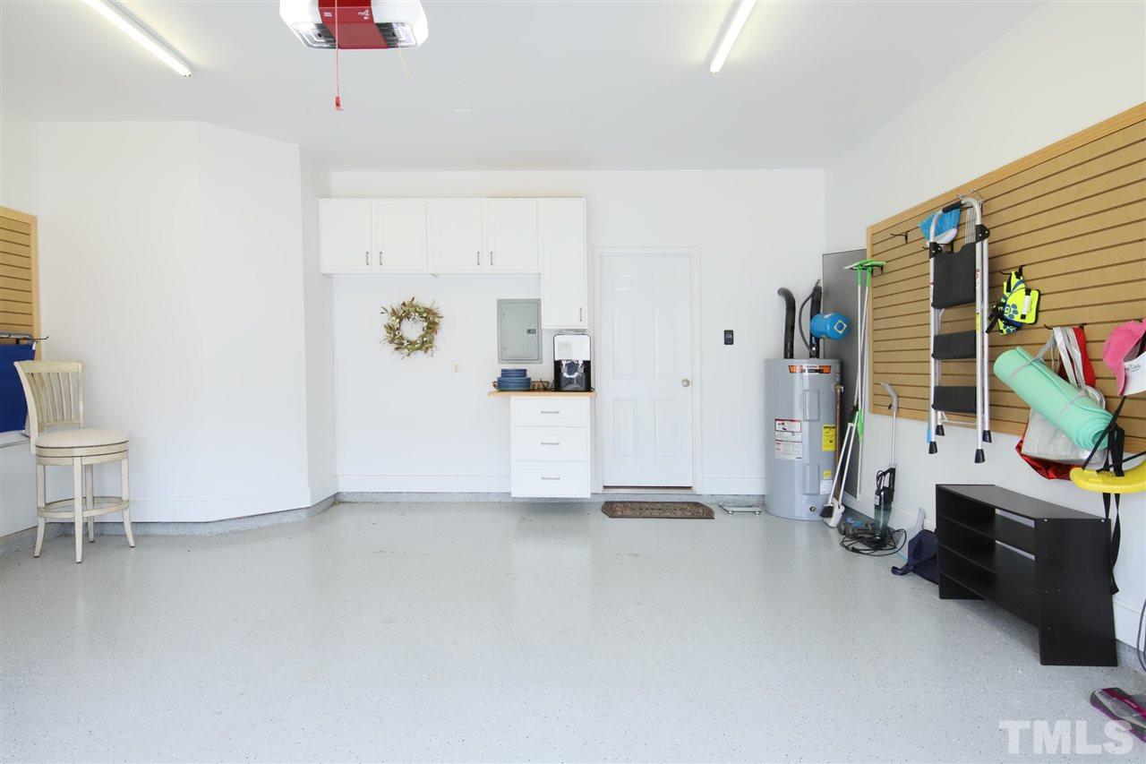 2412 Pumpkin Ridge Way Raleigh, NC 27604 - Photo 3 of 30 2 car garage with shelves and cabinets. epoxy floor