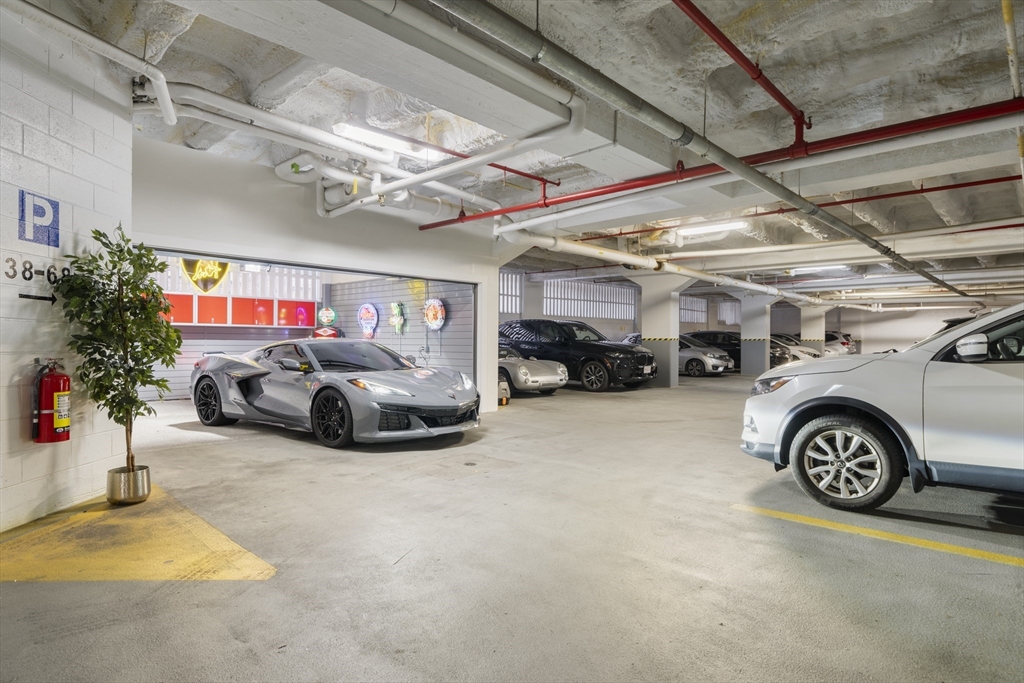 12 Stoneholm Street, Unit PKG:A Boston, MA 02115 - Photo 5 of 10 a view of parking garage with cars parked