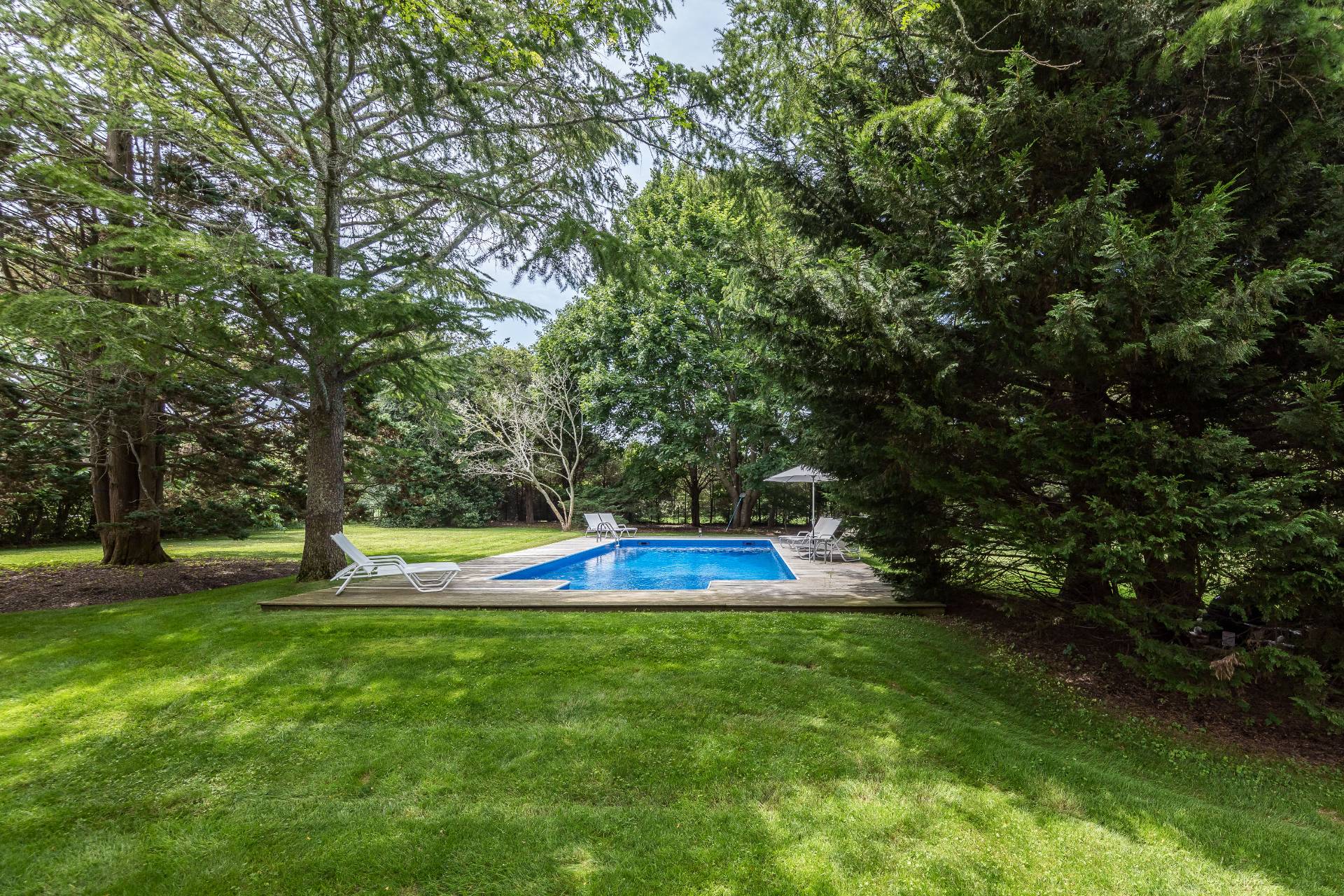 24 Audubon Avenue Bridgehampton, NY 11932 - Photo 12 of 13 a view of a swimming pool with a yard