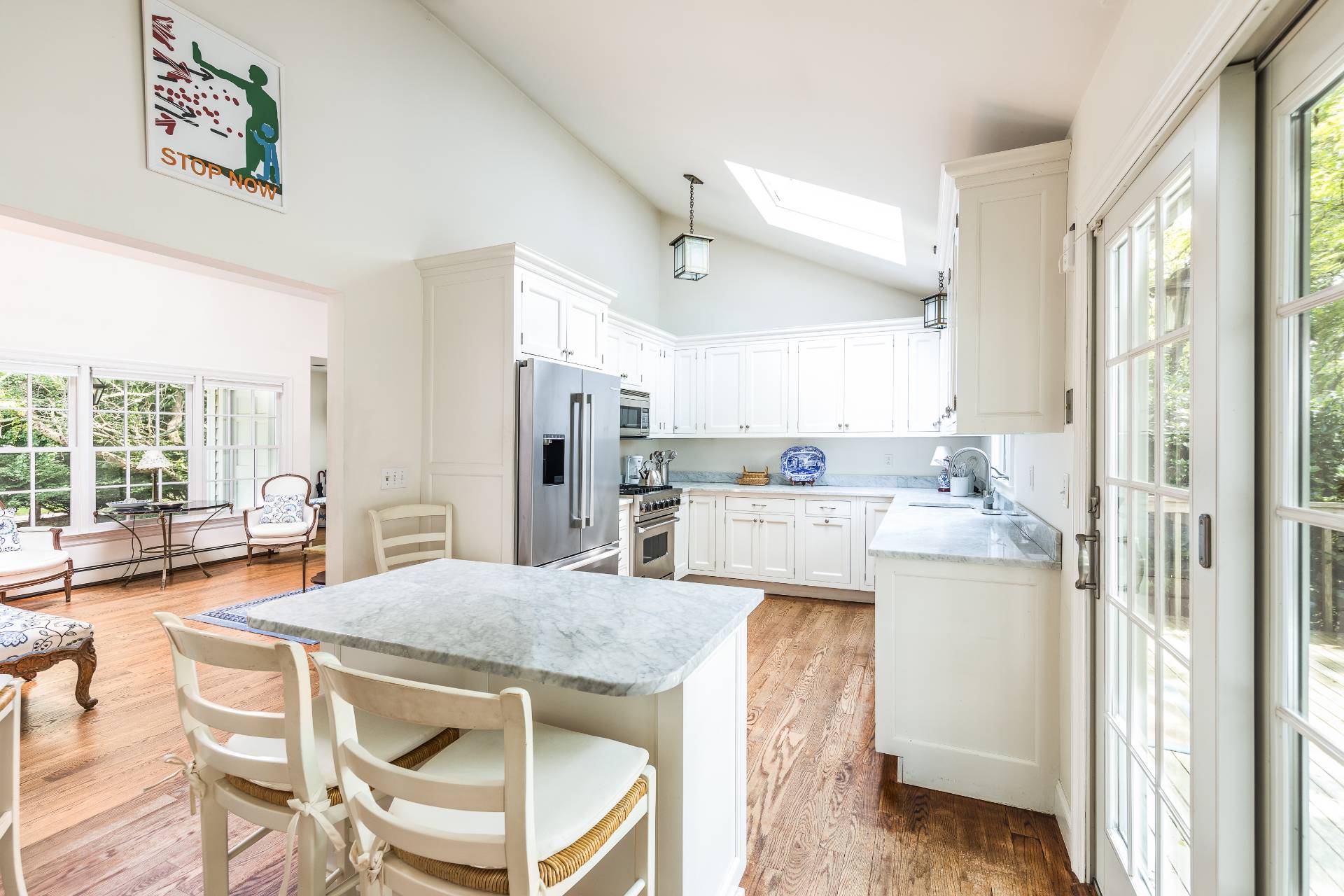 24 Audubon Avenue Bridgehampton, NY 11932 - Photo 7 of 13 a kitchen with stainless steel appliances kitchen island granite countertop a refrigerator and a stove top oven