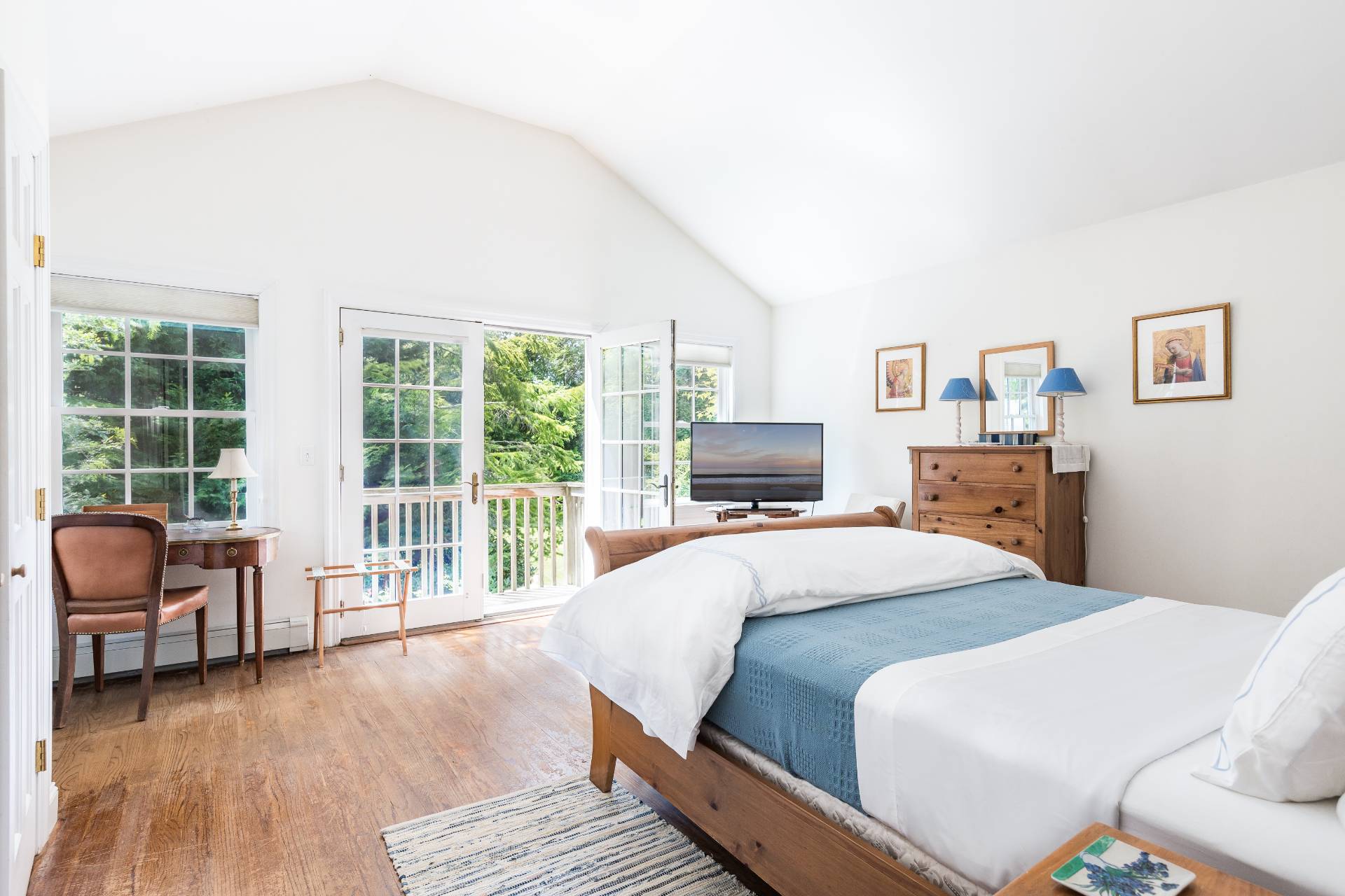 24 Audubon Avenue Bridgehampton, NY 11932 - Photo 9 of 13 a bedroom with a balcony a bed and glass window