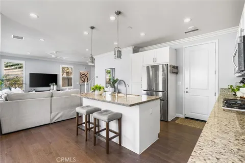 a large kitchen with kitchen island granite countertop a large window and stainless steel appliances