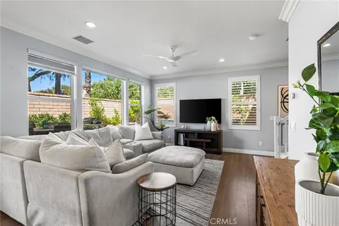 a kitchen with kitchen island granite countertop a sink and white cabinets