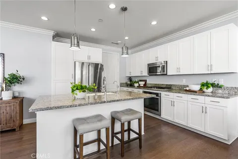 a kitchen with stainless steel appliances granite countertop a sink and a granite counter tops