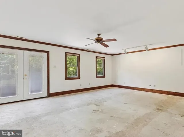 a view of an empty room with windows