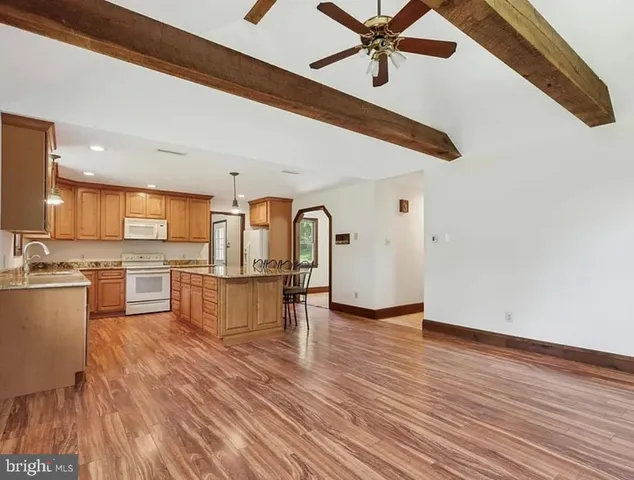 a view of kitchen with sink microwave and stove