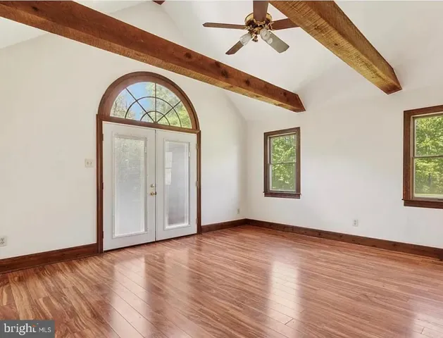 a view of an entryway with wooden floor