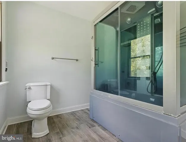 a bathroom with a toilet and a shower