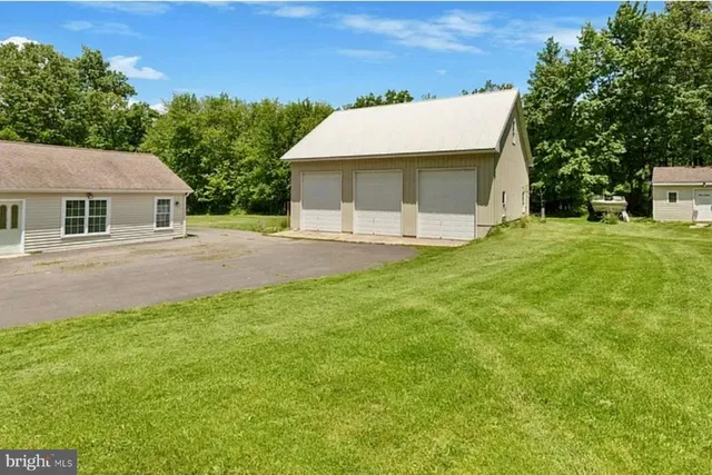 a front view of a house with a garden and yard