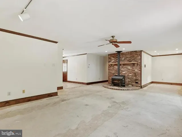 an empty room with a empty space and windows