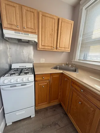 a kitchen with granite countertop cabinets stainless steel appliances and a sink