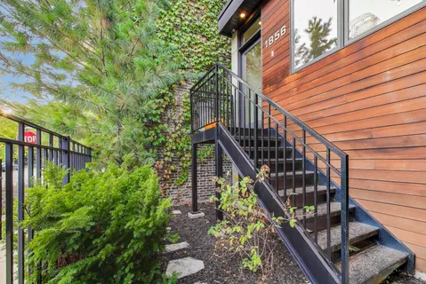 a kitchen with kitchen island a sink a stove a dining table and chairs