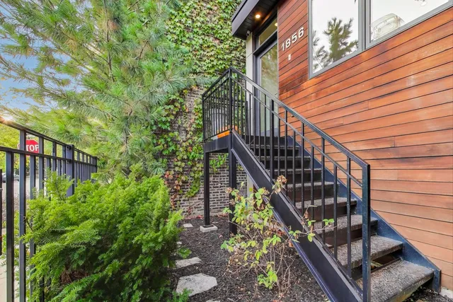a kitchen with kitchen island a sink a stove a dining table and chairs