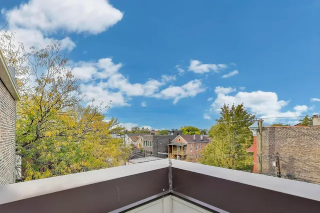 a view of a patio with table and chairs potted plants and a large tree