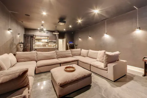 a roof deck with couches and wooden floor