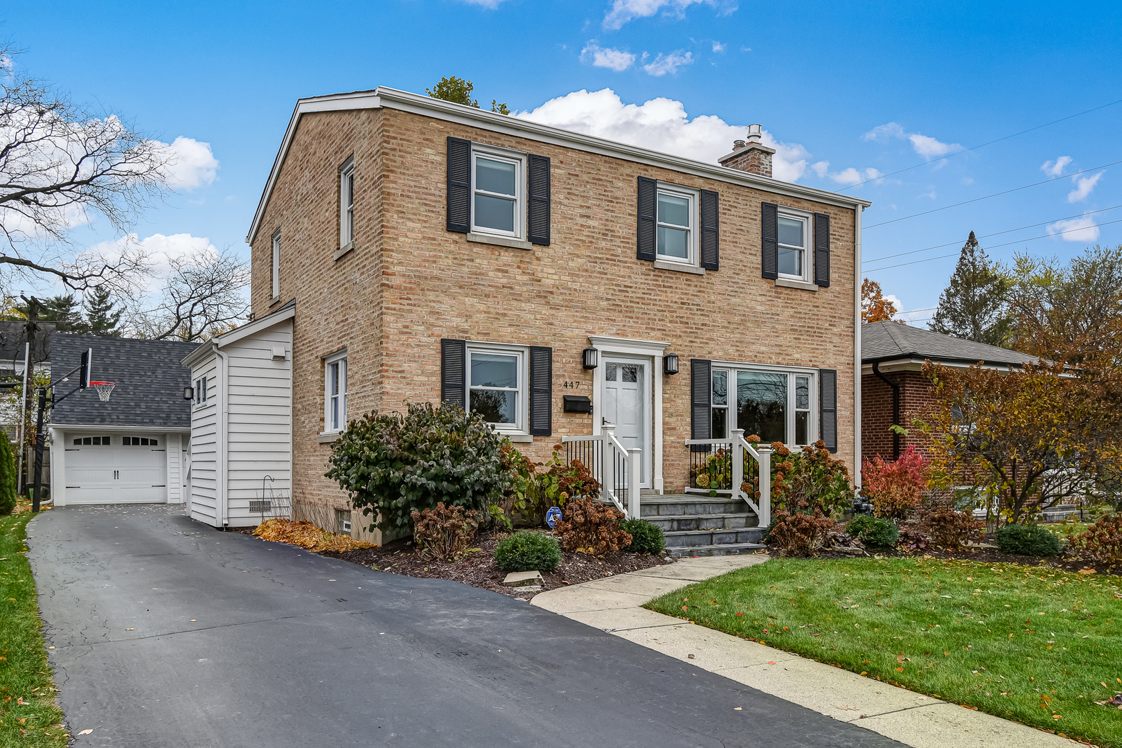 447 Ridge Avenue Clarendon Hills, IL 60514 - Photo 1 of 39 a front view of a house with a garden
