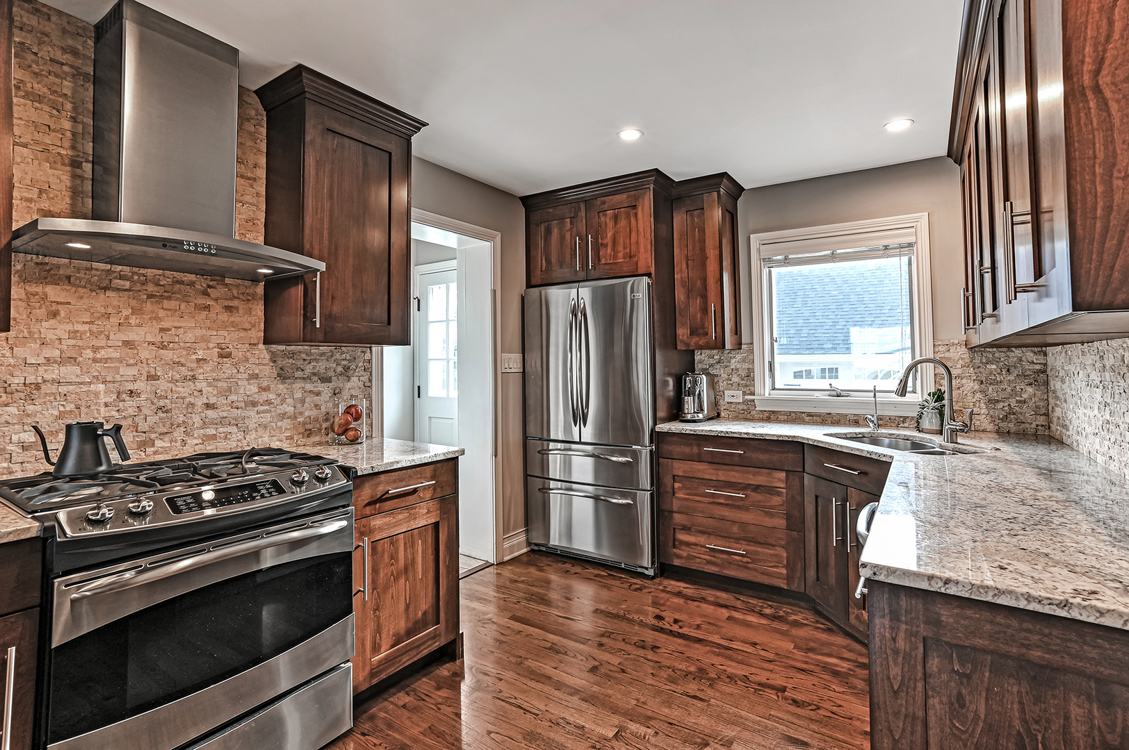 447 Ridge Avenue Clarendon Hills, IL 60514 - Photo 11 of 39 a kitchen with granite countertop stainless steel appliances and wooden cabinets