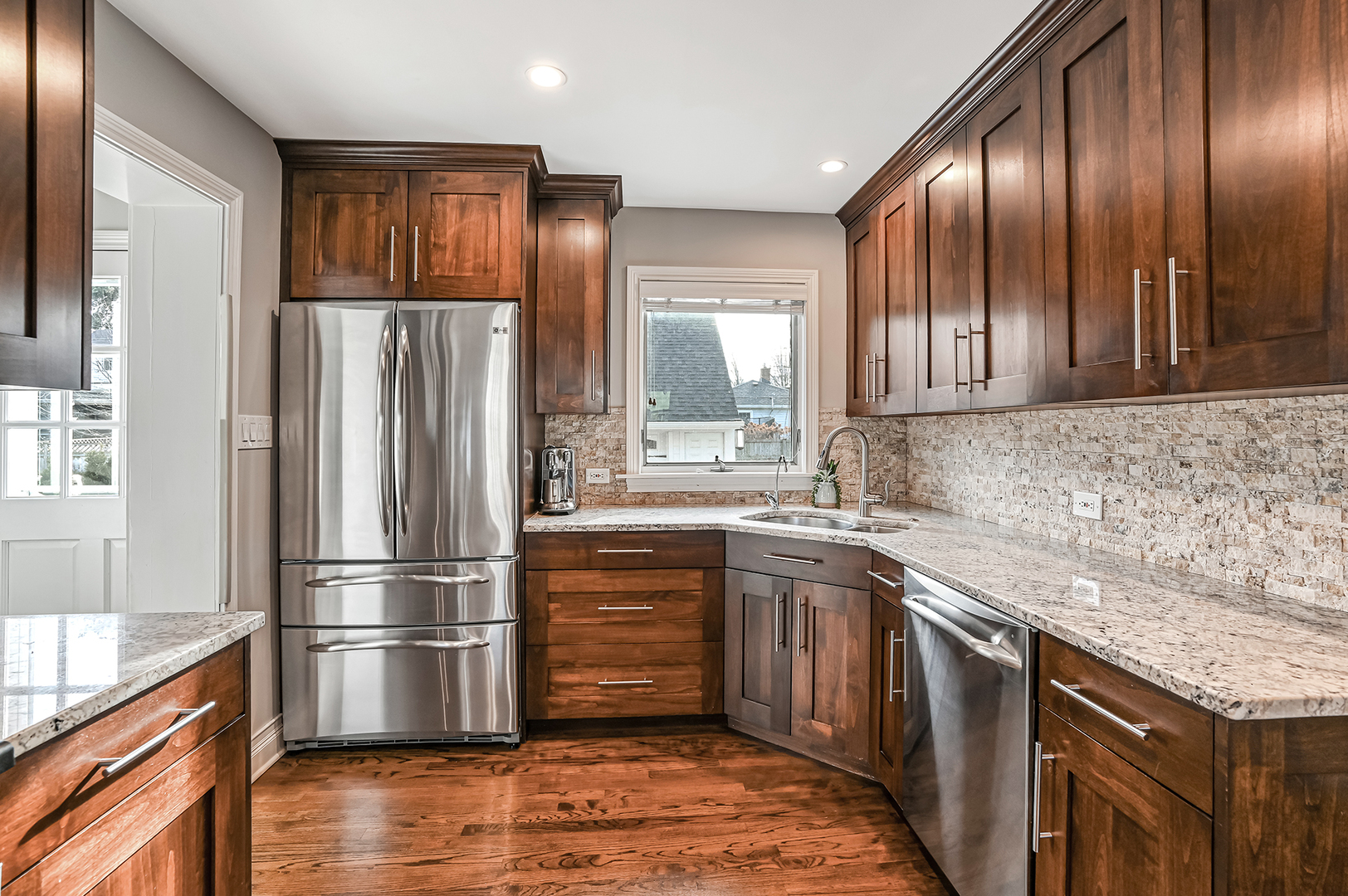 447 Ridge Avenue Clarendon Hills, IL 60514 - Photo 12 of 39 a kitchen with granite countertop stainless steel appliances a refrigerator and wooden cabinets