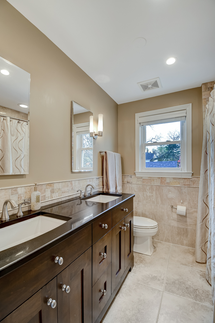 447 Ridge Avenue Clarendon Hills, IL 60514 - Photo 25 of 39 a bathroom with a granite countertop sink mirror vanity and toilet