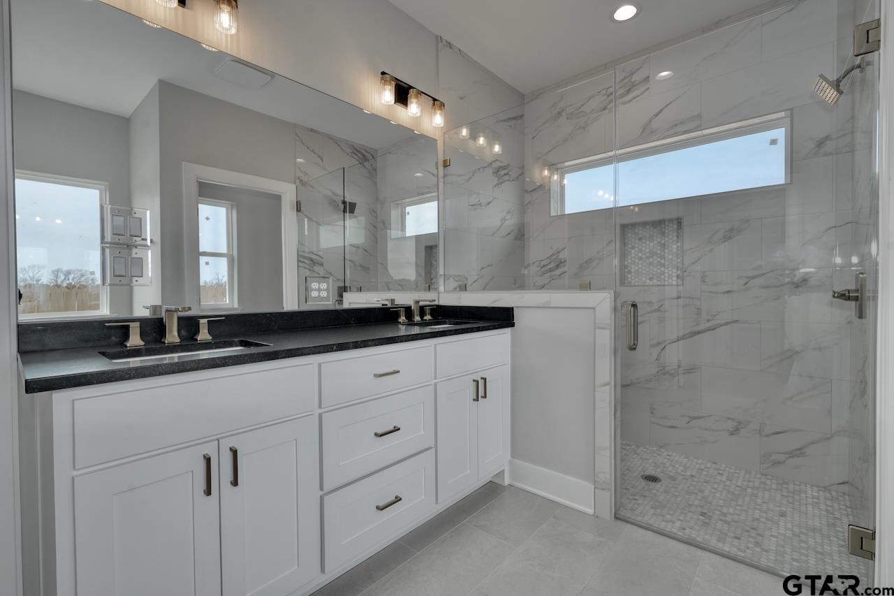 636 Prince Lane Tyler, TX 75704 - Photo 20 of 38 a bathroom with a sink and a mirror