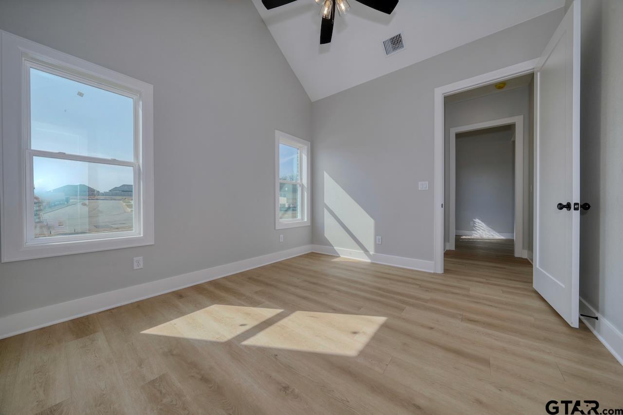 636 Prince Lane Tyler, TX 75704 - Photo 22 of 38 an empty room with wooden floor and windows