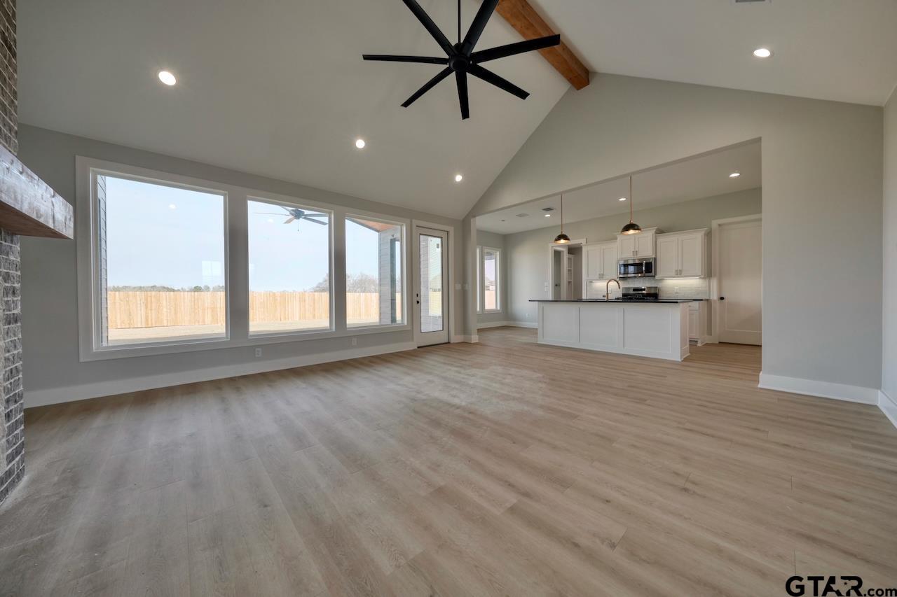 636 Prince Lane Tyler, TX 75704 - Photo 3 of 38 a view of an empty room with a window and wooden floor