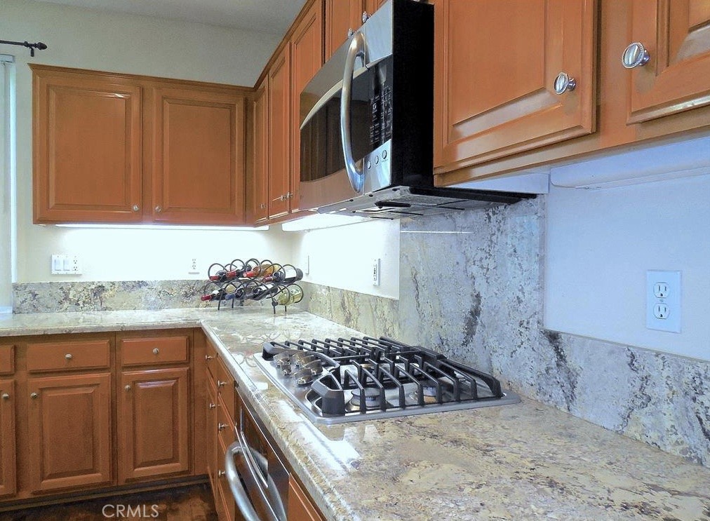 26 Colorado Irvine, CA 92606 - Photo 3 of 26 a kitchen with stainless steel appliances granite countertop a stove a sink and a microwave