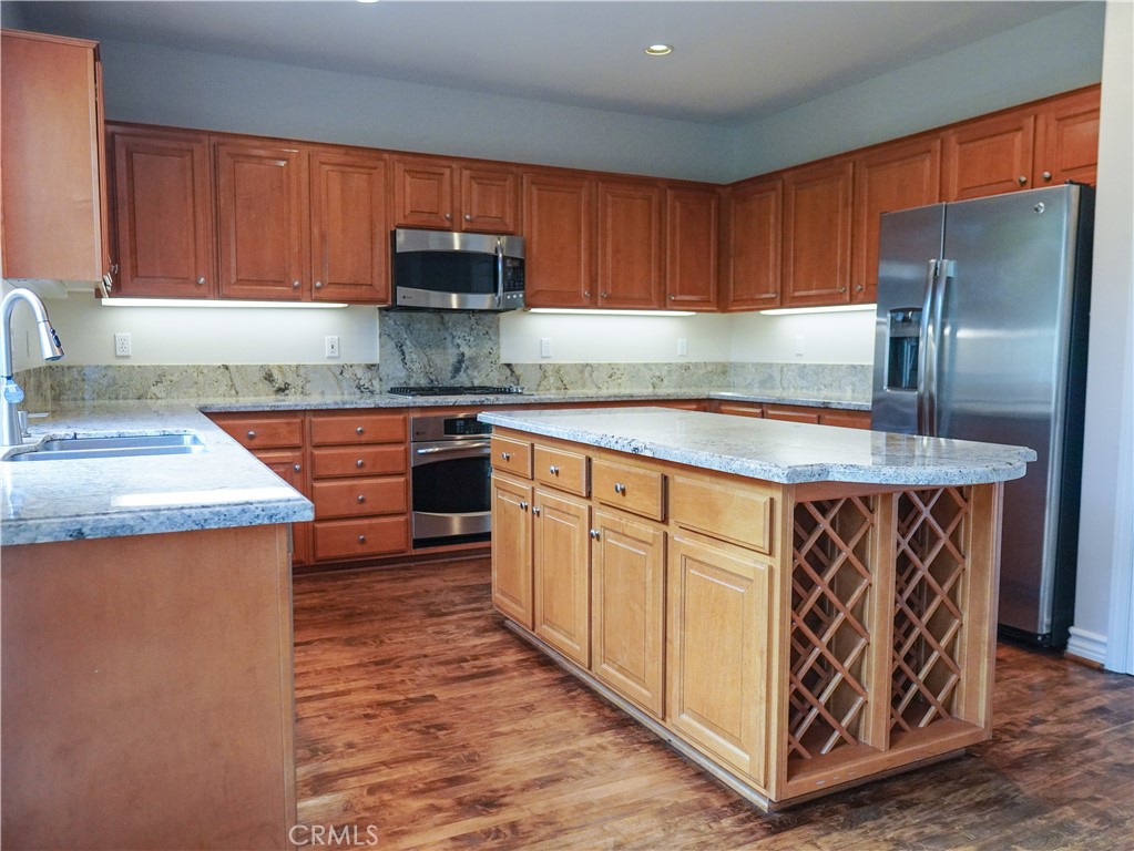 26 Colorado Irvine, CA 92606 - Photo 4 of 26 a kitchen with stainless steel appliances granite countertop a sink stove and refrigerator
