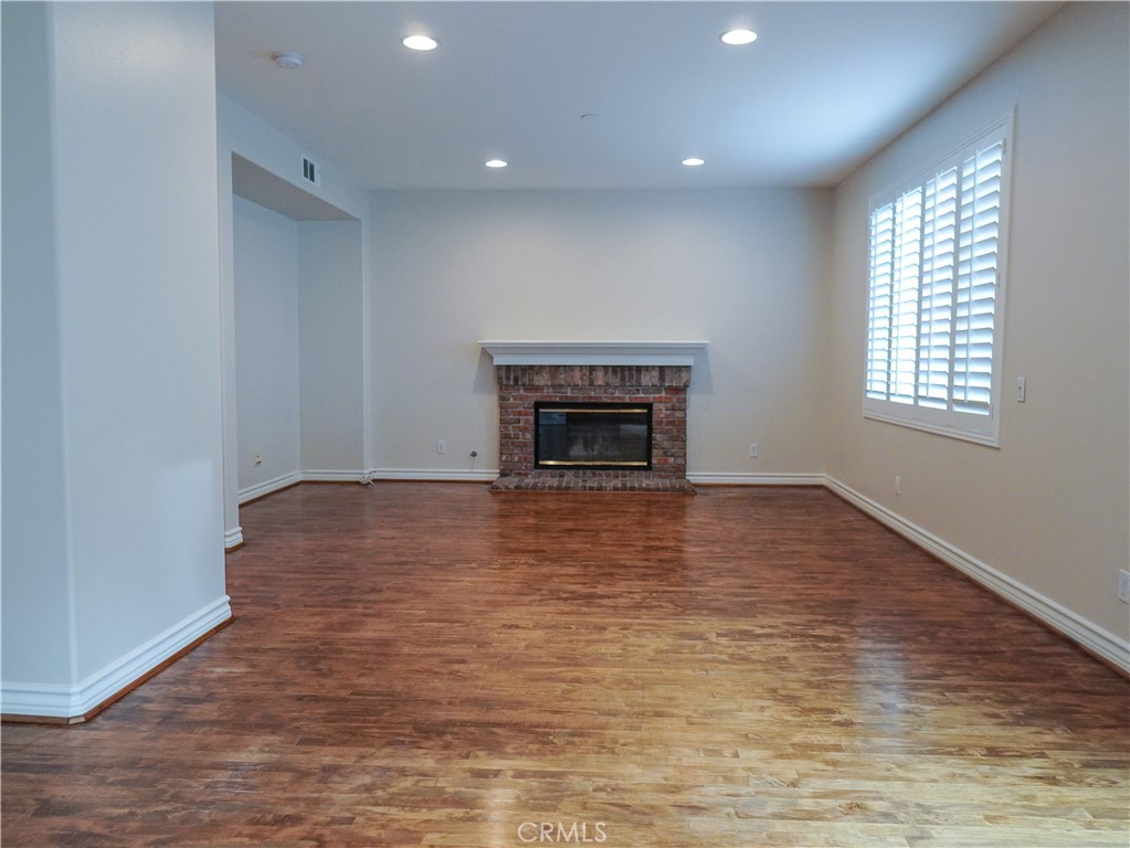 26 Colorado Irvine, CA 92606 - Photo 6 of 26 an empty room with wooden floor fireplace and windows