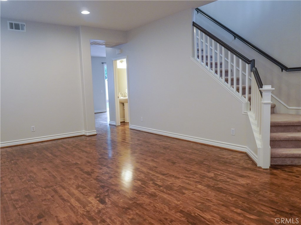 26 Colorado Irvine, CA 92606 - Photo 8 of 26 a view of an empty room with wooden floor and stairs